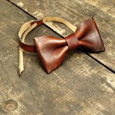 Leather Bow Tie: This bowtie is perfect for your stylish outfits. Get more compliments. Works great as a gift too! HIGH QUALITY: This bow ties is made with very high quality 100% genuine leather, which gives it the perfect look. 100% genuine fullgrain cowhide leather SIZING: Specially designed with an adjustable strap to be a one size fits all which makes it very universal and versatile COLORS: vino OCCASSION: Perfect for any occasion like meetings, service, convention, wedding, graduation, cele Classic Bow Tie For Gifts, Classic Bow Tie Gift, Brown Bow Tie For Party, Classic Detachable Bow As A Gift, Adjustable Brown Bow Tie For Party, Adjustable Brown Bow Tie In Dapper Style, Adjustable Brown Bow Tie For Business, Brown Bow Ties For Black Tie Occasion, Dapper Brown Bow Tie With Tie Back