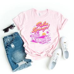 Looking for a cute versatile top to wear? Make sure to grab one of our Graphic tees! This soft and comfortable graphic tee is the perfect top for any outfit. It can be paired with biker shorts, jeans, or even a simple skirt/dress! This tee is true-to-size, so be sure to order your regular t-shirt size! If you are looking for a more oversized look, make sure to size up! Pink Graphic Print T-shirt For Loungewear, Retro Graphic Print T-shirt For Spring, Spring Screen Print T-shirt For Loungewear, Retro Letter Print T-shirt For Spring, Funny Print Tops For Spring Loungewear, Funny Print Tops For Spring Streetwear, Trendy Funny Print Tops For Loungewear, Trendy Tops With Funny Print For Loungewear, Spring Graphic Tee With Text Print