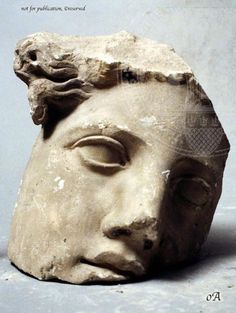 an ancient head is shown on the table