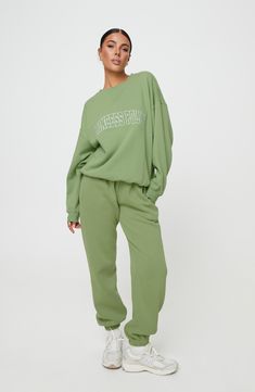 An arched embroidered-logo design brands this relaxed sweatshirt featuring dropped shoulders and cozy ribbed trim. Crewneck   Dropped shoulders   Ribbed cuffs and hem   52% recycled polyester, 48% organic cotton   Machine wash, dry flat   Imported Oversized Green Athleisure Sweats, Solid Color Relaxed Fit Sweats With Ribbed Cuffs, Green Oversized Sporty Sweats, Oversized Sweats With Elastic Cuffs, Sportswear Style Sweatshirt With Ribbed Cuffs For Leisure, Sporty Sweats With Ribbed Cuffs And Relaxed Fit, Oversized Green Sweats For Fall, Green Oversized Sweats For Fall, Spring Relaxed Fit Sportswear Sweatshirt