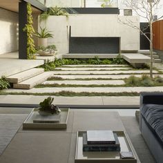 a living room with a couch, coffee table and stairs leading up to the top floor