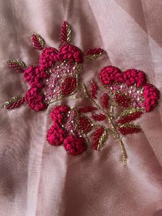 a close up of a piece of cloth with flowers on it and sequins