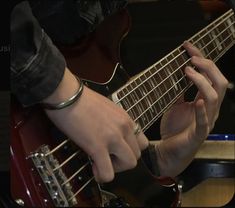 a person playing an electric guitar with their hands