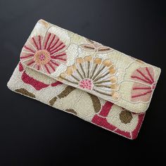 Hi ladies, this beautiful clutch bag will make you fall in love with the colors and design.  Carry with your matching dresses and wait for a million compliments. A beautiful shade of pink and pearl white adds to the whole look and the craftsmanship is topnotch.   Clutches come with detachable string, which you can add if you like and it is amazing without it too.  The size of this clutch is 9x6inch and the rear size is a comfortable cotton fabric so that it is easy to carry it with your dresses. This can be an amazing gift this Thanksgiving, Christmas, and New Year.  A gift wrap option is also available and we will love to pack it for your loved ones! For the first time, we are adding an amazing collection of clutches to our store, all handmade with love in India. Spring Clutch Evening Bag, Spring Clutch Evening Bag As Gift, Spring Clutch Evening Bag For Gift, Elegant Spring Gift Clutch, Feminine Beige Rectangular Evening Bag, Pink Beaded Rectangular Clutch, White Summer Clutch For Formal Occasions, Pink Rectangular Beaded Clutch, Rectangular Pink Beaded Clutch