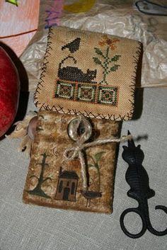 an apple sitting on top of a table next to a pair of scissors and some other items