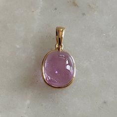 ITEM DESCRIPTION: >> The pendant is made from Solid 14K Yellow Gold. Gemstone used is absolutely natural and ethically sourced. >> Natural Kunzite in cabachon and bezel setting is studded on it with utmost precision. >> This is a minimalist design and is absolutely hassle-free and everyday jewelry. Gem: Kunzite Gem size: 9x11 mm oval Gem weight: 7.13 carats Gold purity: 14K (58.33% approx.) Gold weight: 0.49 grams Gross weight: 1. 92 grams The Gold purity is guaranteed and it comes with authenti Fine Jewelry Cabochon Gemstone Pendant, Hallmarked Yellow Gold Gemstones For Gift, Yellow Gold Gemstones With Bezel Setting, Pink Gold Jewelry With Bezel Setting For Formal Occasions, Pink Gold Formal Jewelry With Bezel Setting, Formal Pink Gold Jewelry With Bezel Setting, 14k Gold Pink Gold Jewelry With Gemstone, Yellow Gold Jewelry With Kunzite Gemstones, Yellow Gold Kunzite Jewelry Gift