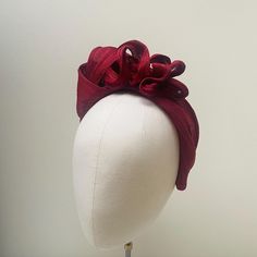 This stunning headpiece has been carefully made using millinery techniques to a high quality. The base band has been crafted with padding and the fabric has been hand stitched for longevity. With no glued elements this piece will set you apart from others in the marketplace.  Also has the option of a beautiful matched burgundy blusher veil fixed to a gold comb. SIZE & FIT: All of my headbands are made using a very flexible Alice band suitable for all head sizes. Unlike other headbands my beautiful fabrics are not glued to a visible,  covered or uncovered base band. They are carefully and sustainably made with the base band sewn into the headband with soft padding for extra structure, longevity and to all day comfort, without the band digging in.  PACKAGING Each headband is wrapped in prett Elegant Fascinator With Structured Crown And Matching Headband, Adjustable Fascinator With Handmade Flowers For Events, Adjustable Sinamay Fascinator With Structured Crown, Formal Fascinator With Handmade Flowers On Headband, Formal Fascinator With Handmade Flowers, Formal Handmade Flowers Fascinator Headband, Elegant Sinamay Headband Fascinator, Formal Adjustable Headband With Handmade Flowers, Adjustable Handmade Flower Headband For Evening