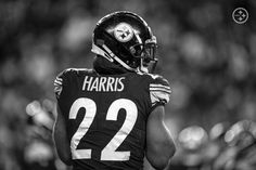 a black and white photo of a football player wearing a helmet with the number 22 on it