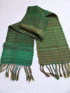 This is hand woven wrap shawl ideal for cold days. In shades of green,made with wool,mohair,acrylic... It is large and thick,so it will warm you easily. Width : 28 cm cm / 11 inLength : 198 cm / 78 in (without fringe),218 cm / 85,8 in ( with fringe)Hand wash in cold water. Lay flat to dry.Made in my studio free of pets and smoke.If you want to see the other headbands in my shop,go here :www.etsy.com/shop/HandweavingbyMima?section_id=15478228&ref=shopsection_leftnav_3Be aware that all computer mo Green Shawl, Shawl Winter, Striped Shawl, Winter Shawl, Woven Wrap, Wool Wrap, Textile Arts, Wrap Shawl, Oversized Scarf