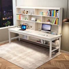 a computer desk with bookshelves and a laptop on it in front of a window