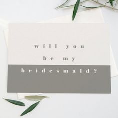 a card with the words will you be my bridesmaid? on it next to some leaves