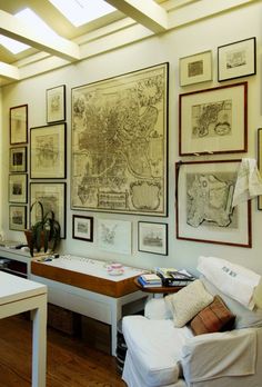 there are many framed maps on the wall