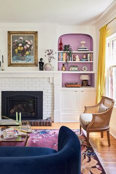 a living room filled with furniture and a fire place in front of a painting on the wall