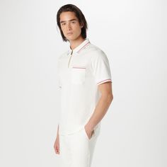 This classic yet stylish short-sleeved polo shirt in 100% Pima cotton features a chest pocket, a quarter zipper closure, a polo collar and double contrast tipping detail, adding a touch of flair to casual. Classic Collared Polo Shirt With 4-way Stretch, Classic Cotton Polo Collar T-shirt, Cotton Polo T-shirt With Contrast Collar, Classic Polo Collar T-shirt With Button Closure, Zip Polo, Cotton Golf Polo Shirt With 4-way Stretch, Polo Collar, Pima Cotton, Quarter Zip