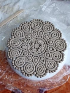 an intricately designed cookie sitting on top of plastic