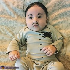 a baby with a fake mustache on it's face