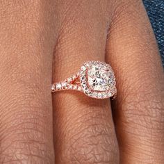 a woman's hand with a diamond ring on top of her finger and an engagement band