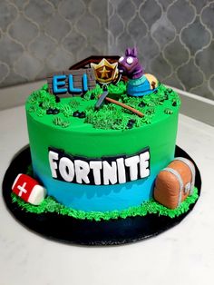 a cake that is sitting on top of a table in the shape of a fortnite