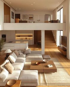 a living room filled with lots of furniture next to a stair case on the wall