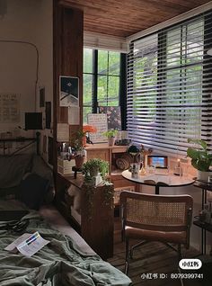 a bedroom with a bed, desk and window covered in blind shades on the windowsill