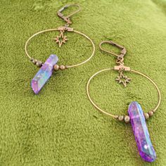 These iridescent purple quartz crystal earrings are the perfect celestial gift idea. Each antique copper hoop earring has a genuine stone hanging beneath an art deco starburst charm and surrounded by dainty copper beads. These earrings are a bold conversation starter. They are a bit heavy due to the fact that these are real quartz crystals, but the ultra light hoop and charms help offset the weight. A gorgeous oddity jewelry set. -Genuine iridescent purple quartz crystals -Art deco starburst cha Handmade Iridescent Metal Jewelry, Mystical Ear Wire For Jewelry Making, Mystical Style Ear Wire For Jewelry Making, Iridescent Adjustable Mystical Jewelry, Iridescent Metal Dangle Jewelry, Celestial Style Drop Earrings For Festivals, Spiritual Copper Drop Earrings, Handmade Celestial Crystal Earrings For Gift, Iridescent Metal Jewelry For Jewelry Making