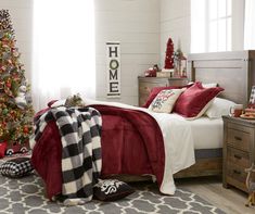 a bedroom decorated for christmas with red and white decor, plaid throw blanket, black and white bedding