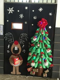 a decorated christmas tree next to a door with reindeer decorations on the front and side