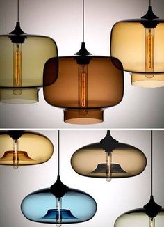 four different shades of colored glass hanging from a ceiling fixture in various shapes and sizes