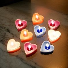 several heart shaped candles sitting on top of a table