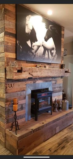 the fireplace is made out of pallet wood and has a horse painting on it