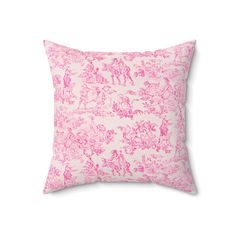 a pink and white pillow with an image of horses on the front, sitting against a white background