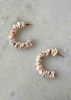 Add a touch of beachy elegance to your outfit with our stunning Shell Hoop Earrings. The unique shell detail on each hoop adds a natural and whimsical touch, while the stacked detailing creates a subtle yet eye-catching look. Perfect for any occasion, these hoops will elevate any outfit with their stylish and elegant design. Chic Hoop Earrings For Beach, White Beaded Hoop Earrings For Beach, Small Hoop Earrings For Vacation, Elegant Small Hoop Earrings For Beach, Shell Hoop Earrings, Your Outfit, Elegant Design, Piercings, Shells