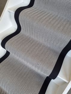 a black and white rug on top of a shelf