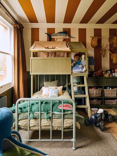 a child's bedroom with striped walls and bunk beds