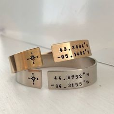 This keepsake design is perfect for commemorating your most treasured memories. The location of the house you grew up in, your first date, where you were married. Honeymoon, your favorite vacation, the possibilities are up to you. This thick gauge cuff is hand formed and stamped in our studio especially for you. We love the modern look of wearing the cuff opening in front. This piece is meant to be worn tight to your wrist and is adjustable. Available in gold or silver finish. Cuff is 1/2 inch t Metal Stamped Jewelry Diy, Affirmation Jewelry, Cool Wrist Tattoos, Dream Trips, Wrist Tattoos For Guys, Metal Stamped Jewelry, Compass Design, Hand Stamped Necklace, Rose Gold Chain