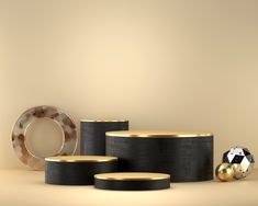 an assortment of black and gold objects on a table