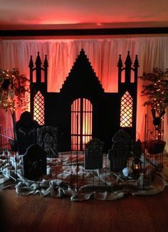 a room decorated for halloween with pumpkins and tombstones