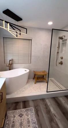 a white bath tub sitting next to a walk in shower