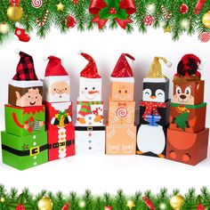 an assortment of christmas gift boxes with santa hats and decorations around them on a white background