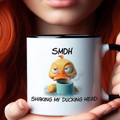 a woman holding a coffee mug with an angry bird on it's side and the caption smh shaking my ducking head