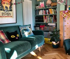 a living room filled with furniture and lots of books