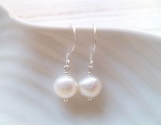 These very pretty earrings are perfect all year around and will make a beautiful addition to any jewellery collection. The earrings are made of Ivory coloured fresh water pearls on 925 Sterling Silver hooks. All of my jewellery is nickel free and is hand made in my Studio at Bradbourne House in East Malling Kent. White Drop Earrings For Bridesmaid Gift, White Round Earrings For Bridesmaids, White Round Earrings For Bridesmaid Gift, White Bridal Earrings For Bridesmaid Gift, White Round Bridal Earrings For Bridesmaid, White Round Bridal Earrings For Bridesmaid Gift, White Pearl Earrings Bridesmaid Gift, White Sterling Silver Earrings For Bridesmaid Gift, Hypoallergenic White Round Bridal Earrings