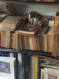 many books are stacked on top of each other in a bookcase, and one is empty