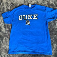 Washed In The Washing Machine And Dried But Then Never Worn. Looks Brand New. Duke University Children’s Medium Shirt. In My Opinion, This Would Fit A 10-Year-Old. Although My 10-Year-Old Never Ended Up Wearing It. Blue Screen Print Shirt For College, Blue Fan Apparel Shirt With Letter Print, Blue School Tops With Text Print, Blue Text Print Tops For School, Blue Letter Print Shirt For Fans, Blue Crew Neck Top For School Spirit, Blue Shirt With Letter Print For Fan Merchandise, Blue Shirt With Letter Print For Fans, Blue Letter Print Shirt For School