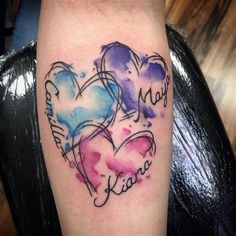 two hearts with names tattooed on the arm