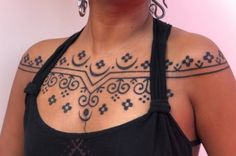 a woman with some tattoos on her chest