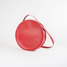 Circular leather shoulder bag. Chic Leather Shoulder Bag With Round Handle, Modern Leather Flap Bag With Round Handle, Evening Leather Shoulder Bag With Round Handle, Red Leather Bags With Round Handle, Red Shoulder Bag With Round Handle For Daily Use, Chic Leather Flap Bag With Round Handle, Evening Bag With Removable Pouch In Round Case, Red Shoulder Bag With Detachable Round Handle, Modern Shoulder Bag With Adjustable Strap And Round Handle