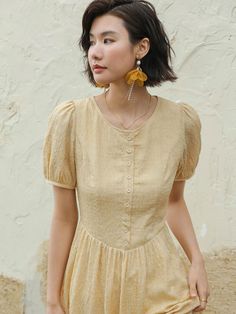 Long, A-line dress in lightweight fabric. Round neckline, buttons at front, and short puff sleeves. Lined.- Maxi- A-line- Round neck Yellow Puff Sleeve Dress, Puff Sleeve Dress, Puffed Sleeves Dress, Lightweight Fabric, Puff Sleeves, Round Neckline, Sleeve Dress, A Line Dress, Puff Sleeve