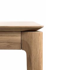 a close up of a wooden table with a white background