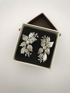 Gorgeous modern style ear cuff decorated with delicately shaped leaves. You can use our ear cuff on the right or left side. Has a rode metal soldered on the back of it that could be opened for an easy wear or squeezed inwards for a secure fit. The set includes a mini zirconium stud earring for the second ear VAT: Value Added Tax (VAT) is a tax that is charged when your parcel reaches the destination country. You may be required to pay VAT in order to receive your parcel. Customs policies and imp Silver Wrap Earrings For Wedding, Silver Elegant Wrap Earrings For Wedding, Elegant Silver Wrap Earrings For Wedding, Silver Drop Earrings For Wedding, Handmade Elegant Ear Climbers, Elegant Handmade Cartilage Earrings As Gift, Elegant Silver Cartilage Earrings For Party, Single Drop Cartilage Earrings For Wedding, Elegant Silver Ear Climbers As Gift